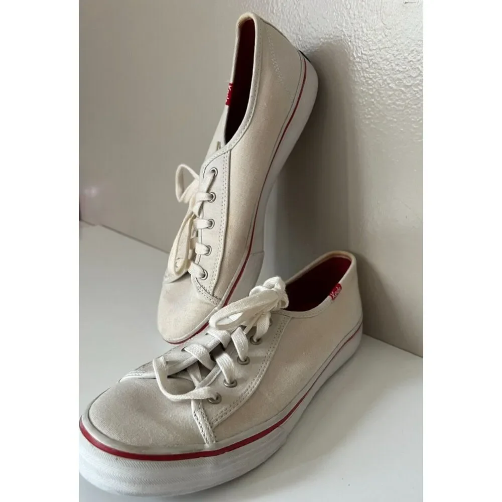 Keds low top canvas lace up sneakers with red trim. Size 8.
